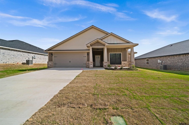 craftsman-style home featuring a garage, central AC, and a front yard