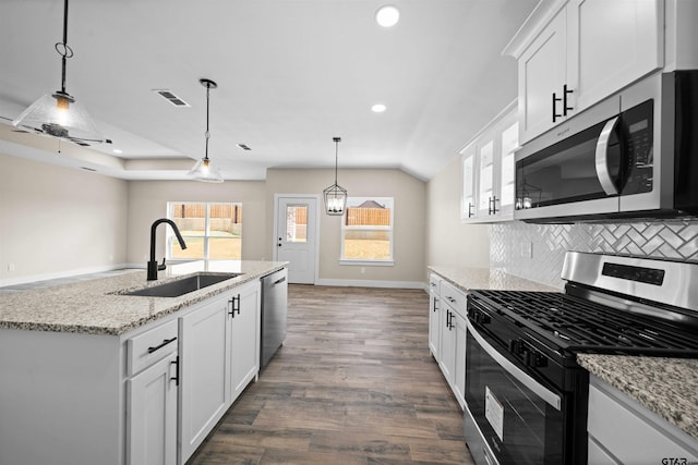 16221 Crossing Cir, Lindale, TX 75771 - kitchen with stainless steel appliances, dark wood-type flooring, white cabinets, hanging light fixtures, and light stone countertops