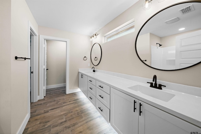 16221 Crossing Cir, Lindale, TX 75771 - full bathroom with double vanity and wood finished floors