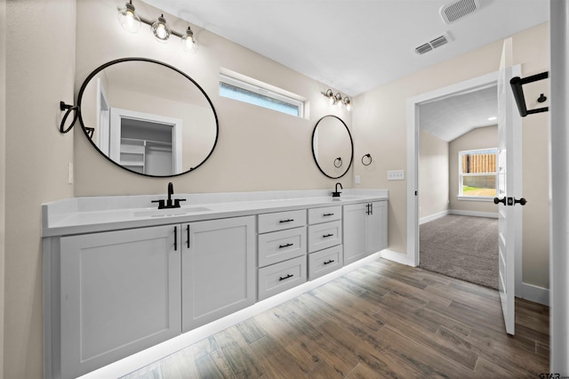 16221 Crossing Cir, Lindale, TX 75771 - full bathroom featuring double vanity, wood finished floors, healthy amount of natural light, and lofted ceiling