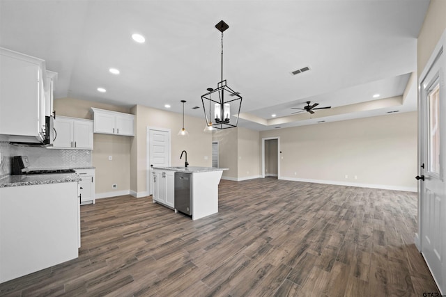 16221 Crossing Cir, Lindale, TX 75771 - kitchen with stainless steel appliances, ceiling fan, open floor plan, white cabinets, and dark wood-style flooring