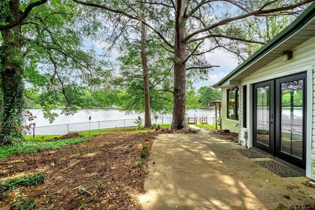 488 Omaha Dr, Omaha, TX 75571 - view of yard with a water view, a patio area, and french doors