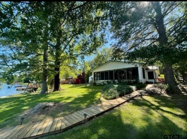 488 Omaha Dr, Omaha, TX 75571 - view of grassy yard featuring a sunroom