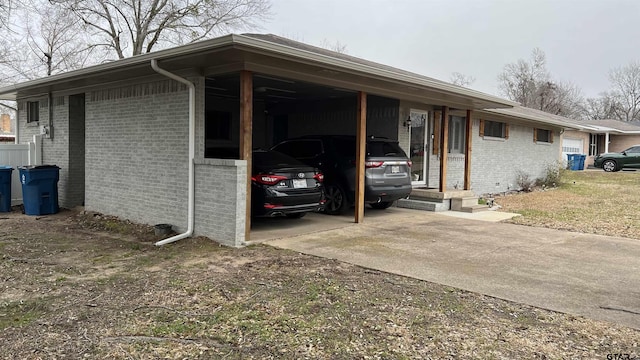 view of parking / parking lot with a carport and concrete driveway