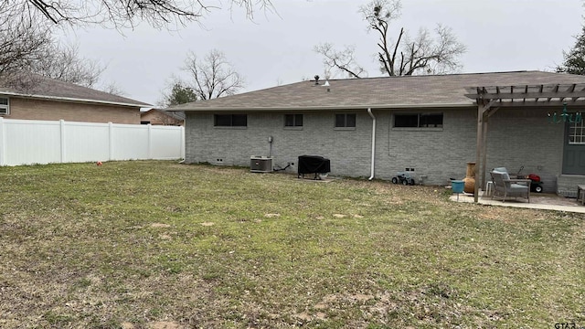 back of house with crawl space, fence, a yard, a pergola, and brick siding