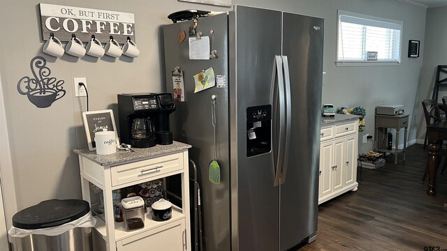 kitchen featuring dark wood-style floors, light stone counters, stainless steel refrigerator with ice dispenser, and white cabinets