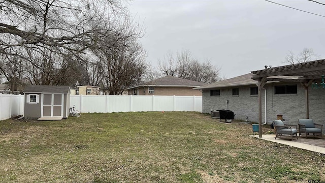 view of yard with a storage shed, a fenced backyard, an outdoor structure, a patio area, and a pergola