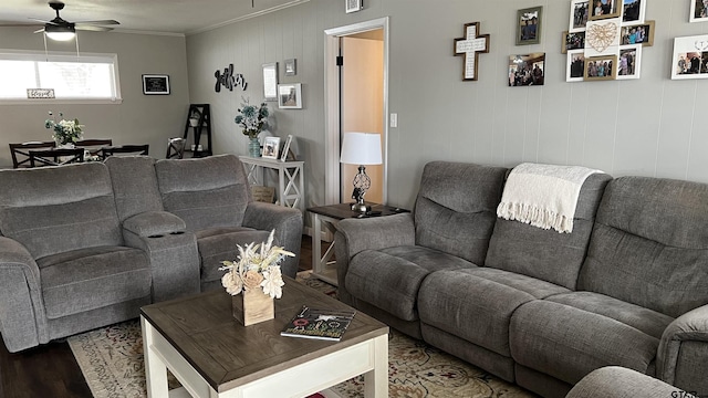 living room with ceiling fan, crown molding, and wood finished floors