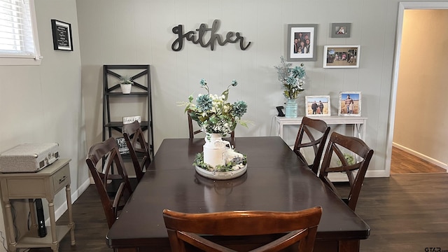 dining area featuring wood finished floors and baseboards