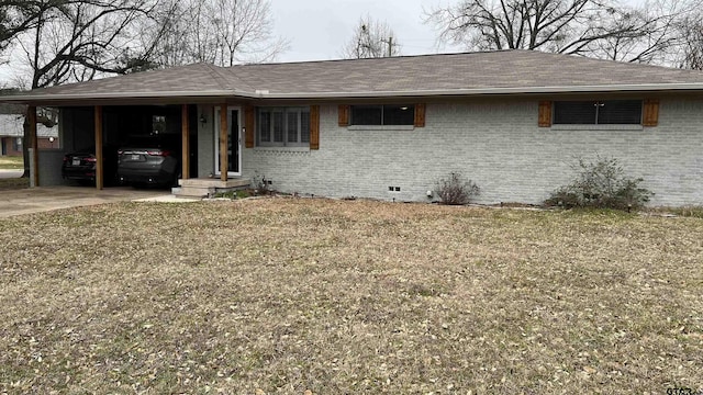 ranch-style house featuring a shingled roof, an attached carport, crawl space, and brick siding