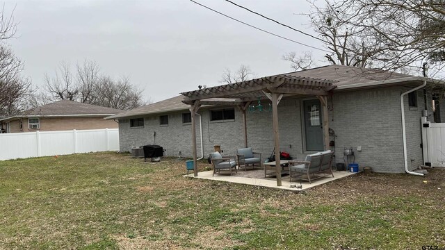 back of house with a lawn, fence, a patio area, a pergola, and brick siding