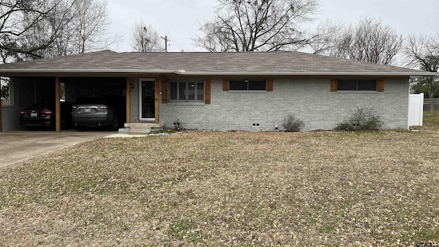 ranch-style house with a carport, crawl space, brick siding, and driveway