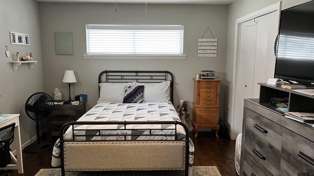 bedroom featuring a closet and dark wood finished floors