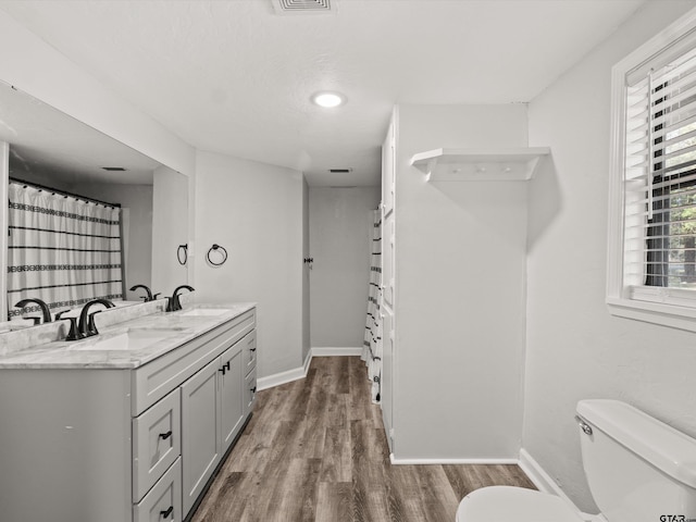 bathroom featuring hardwood / wood-style floors, vanity, and toilet