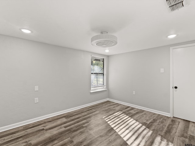 empty room with dark hardwood / wood-style flooring