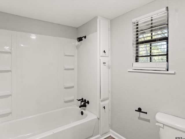 bathroom featuring toilet and washtub / shower combination