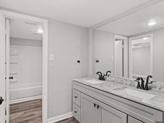 bathroom with vanity, bathtub / shower combination, and hardwood / wood-style flooring