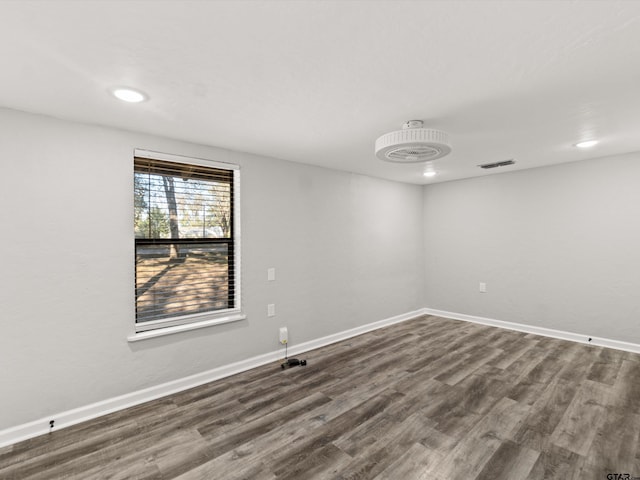 unfurnished room with dark hardwood / wood-style floors