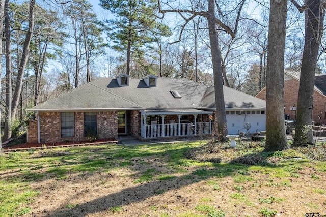 view of front of home featuring brick siding, roof with shingles, and an attached garage