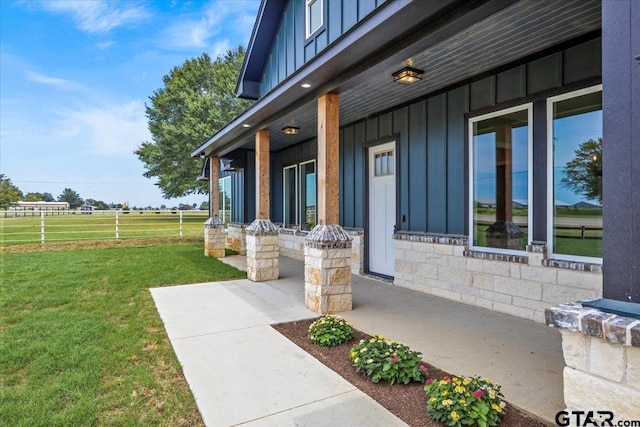 view of exterior entry with a lawn