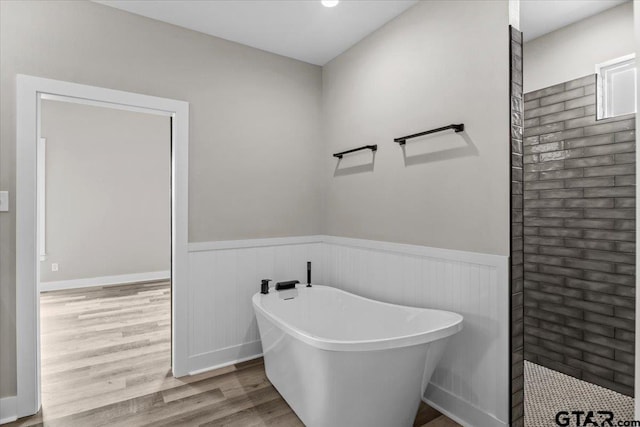 bathroom featuring a washtub and hardwood / wood-style floors