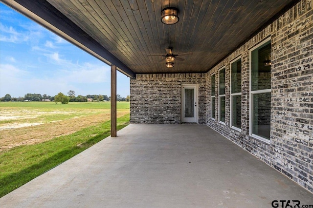 view of patio / terrace featuring a rural view and ceiling fan