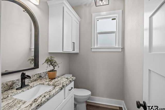 bathroom featuring vanity, toilet, and wood-type flooring