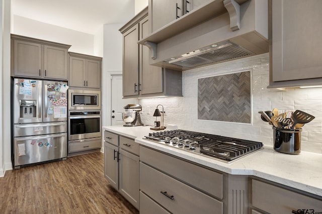 9157 Teal Flight Way, Tyler, TX 75703 - kitchen featuring appliances with stainless steel finishes, wall chimney range hood, and gray cabinetry