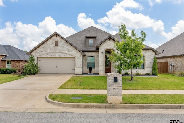 9157 Teal Flight Way, Tyler, TX 75703 - french country inspired facade with brick siding, driveway, an attached garage, a shingled roof, and stone siding