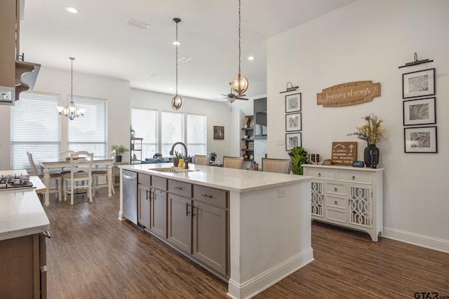 9157 Teal Flight Way, Tyler, TX 75703 - kitchen with a chandelier, a sink, dark wood finished floors, recessed lighting, and light stone countertops