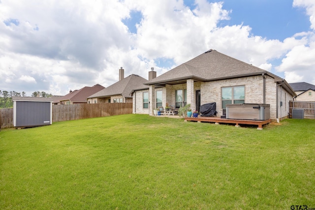 9157 Teal Flight Way, Tyler, TX 75703 - rear view of property featuring a storage shed, an outbuilding, brick siding, central air condition unit, and roof with shingles