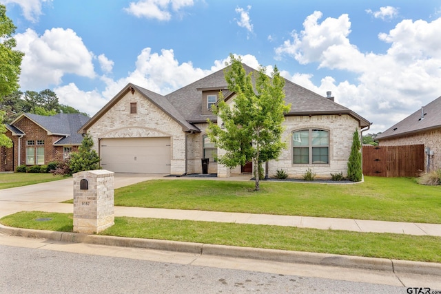 9157 Teal Flight Way, Tyler, TX 75703 - french provincial home with driveway, stone siding, an attached garage, and brick siding