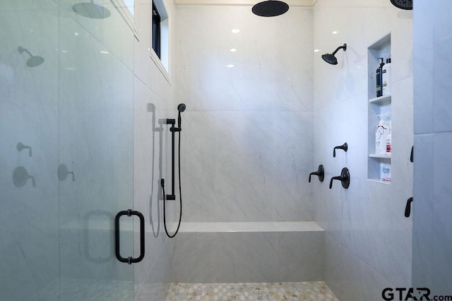 bathroom featuring a shower with shower door