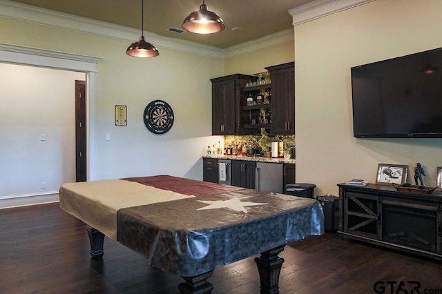 rec room with ornamental molding, dark wood-type flooring, bar, and pool table