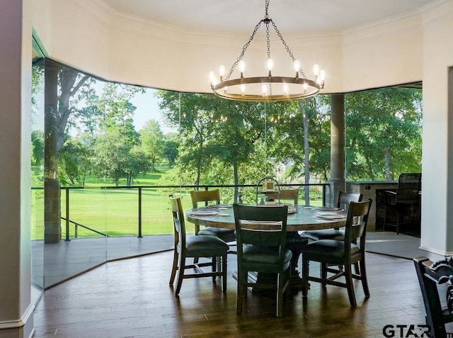 dining room with a notable chandelier, crown molding, and wood-type flooring