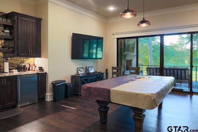 recreation room with dark hardwood / wood-style flooring, pool table, ornamental molding, and indoor bar