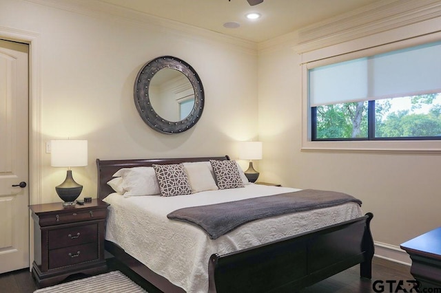 bedroom featuring ornamental molding and dark wood-type flooring