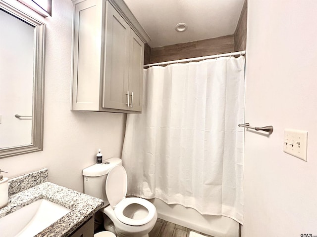 full bathroom featuring vanity, wood-type flooring, toilet, and shower / bath combo with shower curtain