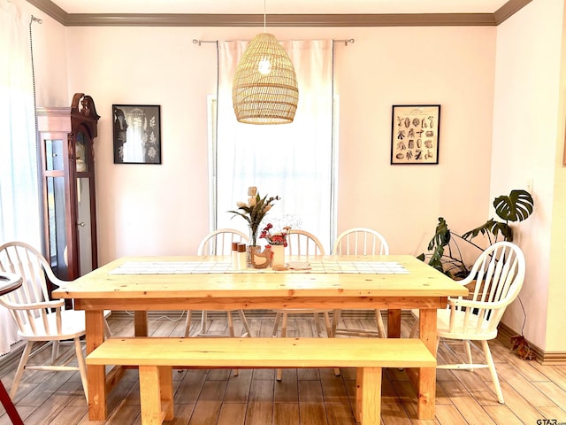 dining room featuring crown molding and hardwood / wood-style flooring