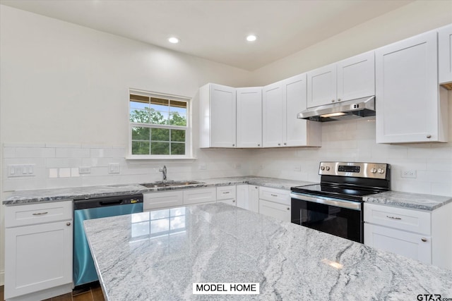 kitchen with stainless steel appliances, white cabinetry, sink, and backsplash