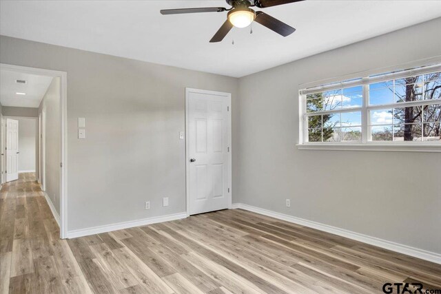 spare room featuring ceiling fan and light hardwood / wood-style floors