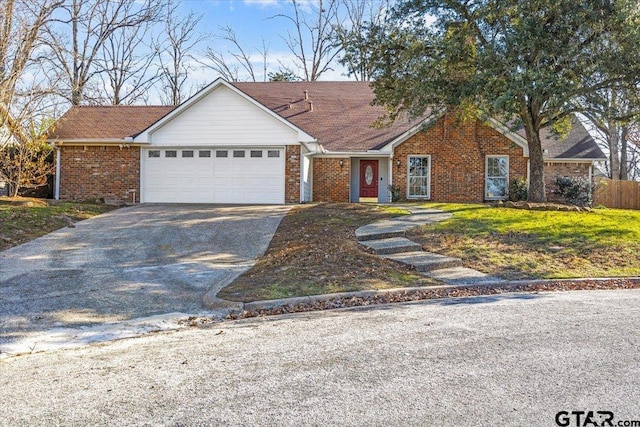 ranch-style house featuring a front lawn and a garage