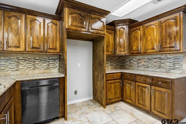 kitchen with dishwasher, decorative backsplash, and light stone counters