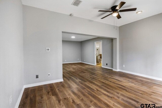 spare room with ceiling fan and dark hardwood / wood-style floors