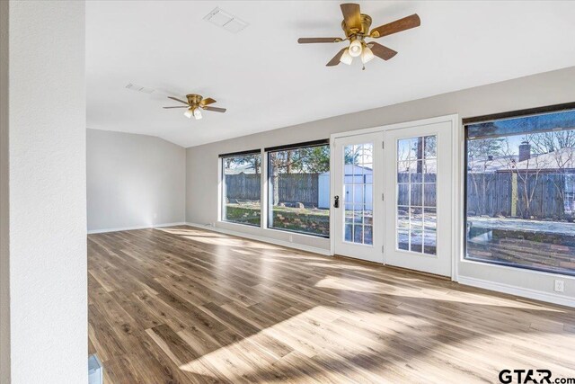 spare room featuring ceiling fan, light hardwood / wood-style floors, and vaulted ceiling