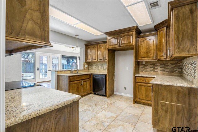 kitchen with kitchen peninsula, decorative backsplash, french doors, sink, and pendant lighting