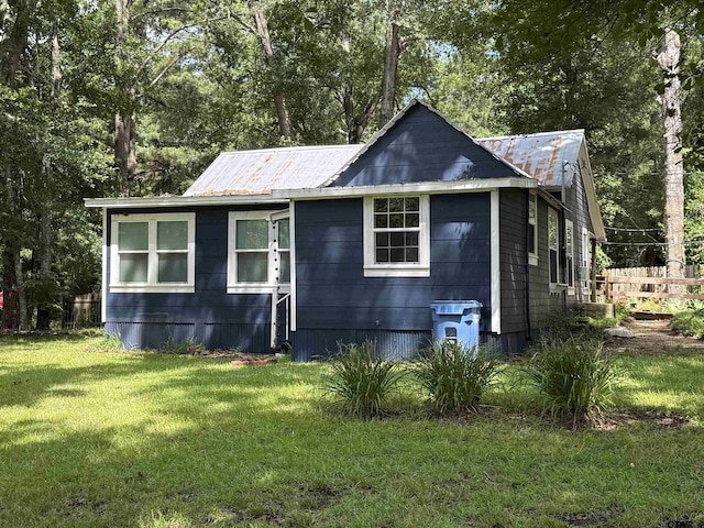 2595 Fm 1857 S, Rusk, TX 75785 - view of property exterior with a lawn, a metal roof, and view of wooded area