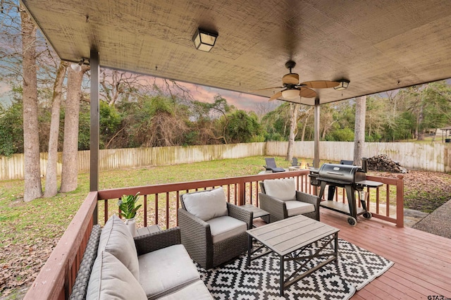 wooden terrace with ceiling fan, a fenced backyard, an outdoor hangout area, and a grill