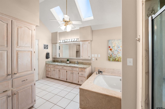 bathroom featuring double vanity, lofted ceiling with skylight, tile patterned flooring, and a sink