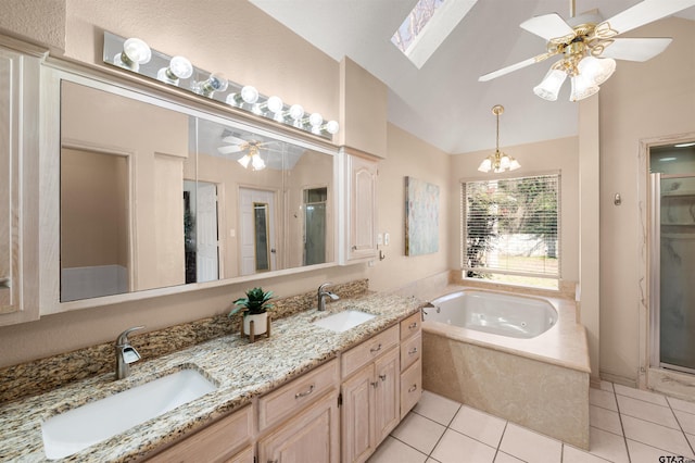 bathroom featuring lofted ceiling, tile patterned flooring, a sink, and a bath